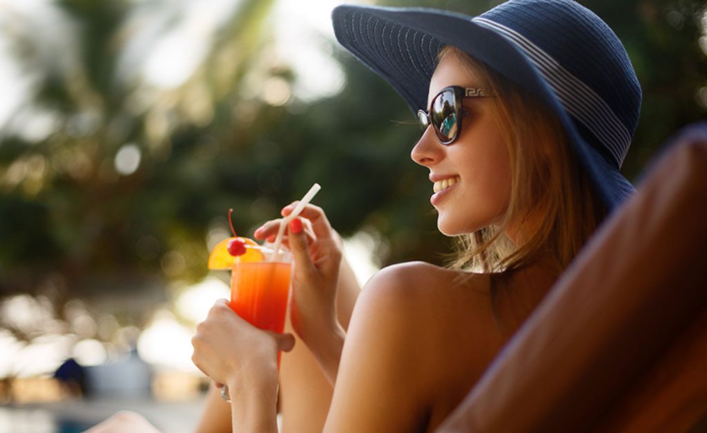 lady drinking a cocktail lakeside