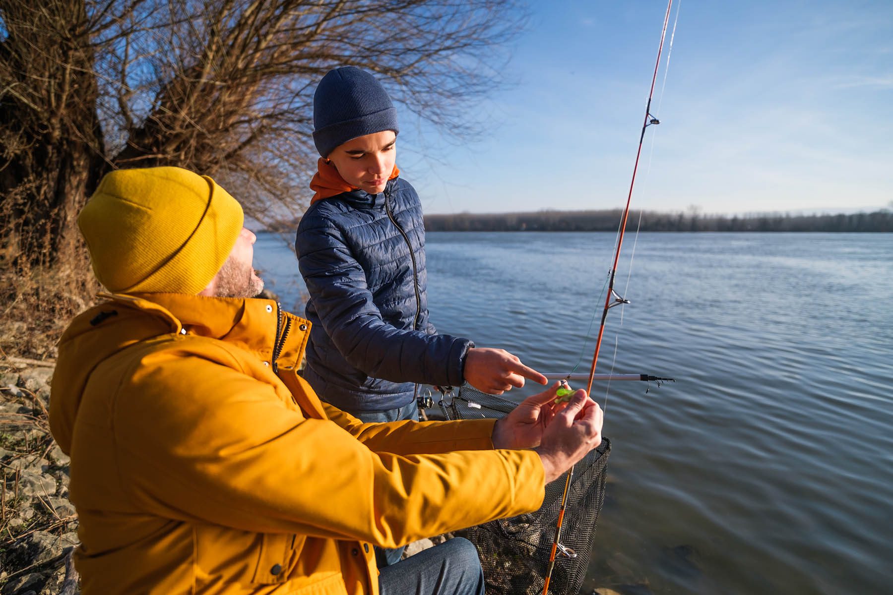 Dad and son winter fishing on lake Anna